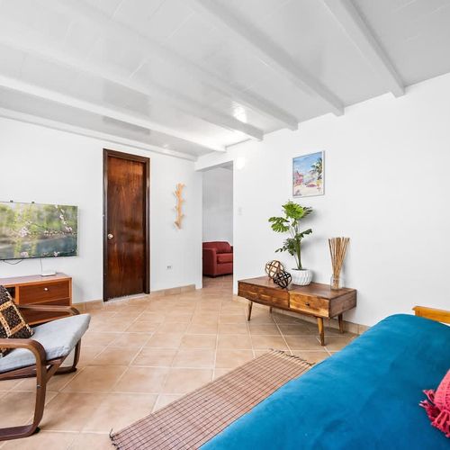 Wind down with your favorite shows in the stylish living room featuring a flat-screen TV and plush seating.