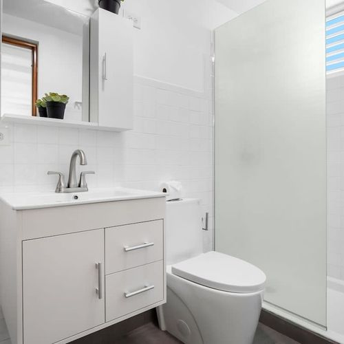 Enjoy a clean and well-maintained bathroom featuring modern fixtures, a sleek vanity with storage, and a bright shower space.