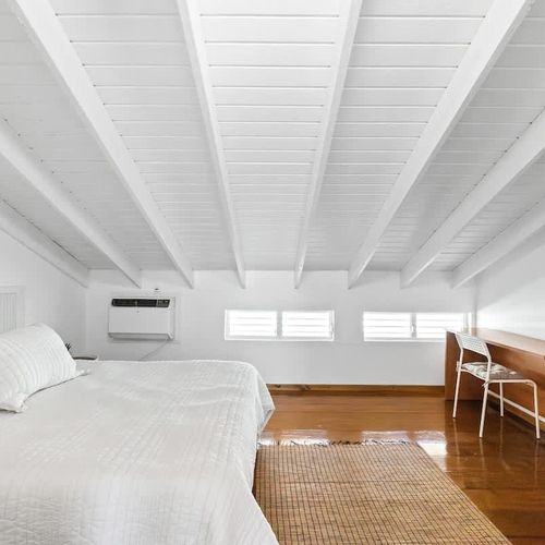 Stay productive with a dedicated work desk in this serene, air-conditioned bedroom retreat.