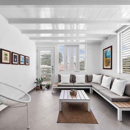 Relax in the inviting living space, complete with a comfy sofa and a bright window that fills the room with daylight – perfect for reading, lounging, or streaming your favorite shows.