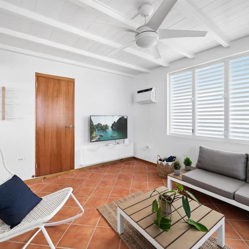 Relaxed island style. A bright and breezy lounge area with comfy seating and cool terracotta floors.