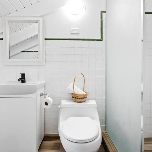 Freshen up in style in this bright, white bathroom with  shower.