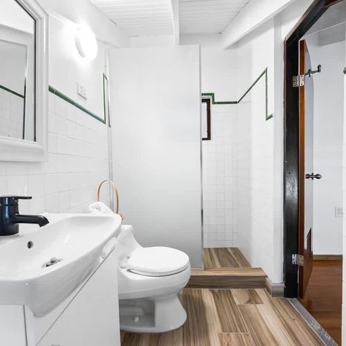 Minimalist and clean – bathroom essentials with mirror and walk-in shower.