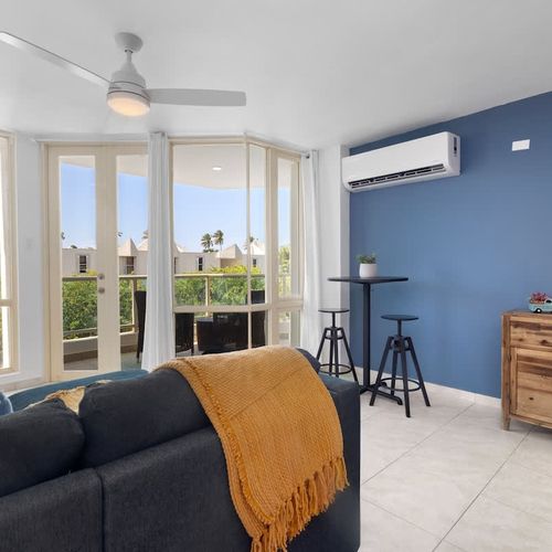 Relax in style! Our comfortable living room seamlessly extends to a private balcony, offering stunning views and a perfect spot to unwind after a day of adventure.