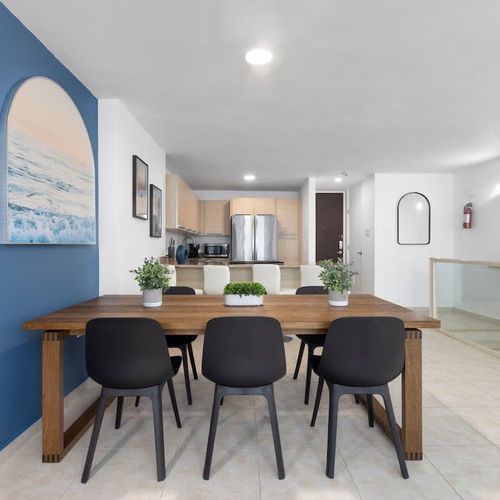 Gather and create memories in this inviting open-concept space. Perfect for shared meals and lively conversations, featuring a stylish dining area and a well-equipped kitchen.