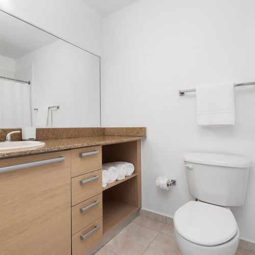 Start your day refreshed! Our modern bathroom features a spacious vanity and pristine fixtures, ensuring a comfortable and convenient experience for all guests.