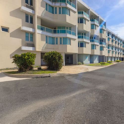 Welcome to your tropical getaway! Our charming building is nestled in a vibrant setting, offering a glimpse of the peaceful environment awaiting your arrival.