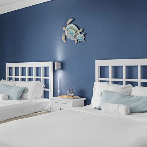 Unwind in a stylish space where comfort meets breathtaking scenery, with two cozy beds and easy access to a balcony that showcases the mesmerizing waterfront.