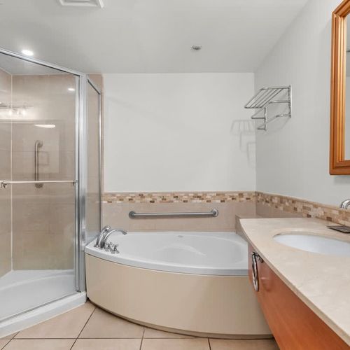 Indulge in relaxation with our luxurious corner soaking tub, perfect for unwinding after a day of exploring San Juan. It's your private spa retreat.