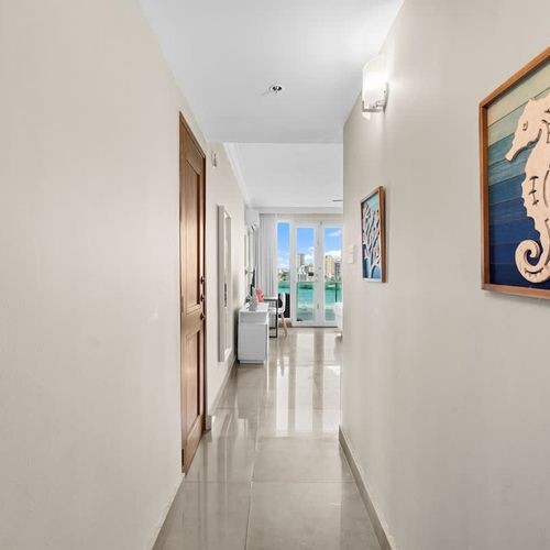 Be greeted by a charming entryway leading to breathtaking water views, setting the tone for an unforgettable stay. The seaside decor adds a touch of coastal charm.