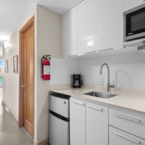 Enter a world of comfort with this fully-equipped kitchenette, perfect for preparing light meals and snacks. The clean, contemporary design creates a welcoming atmosphere for your stay.