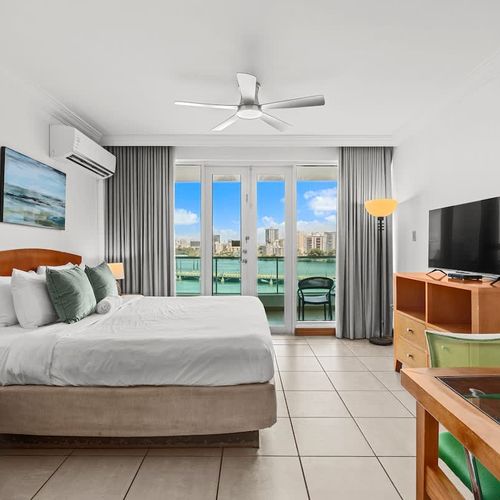 Relax and unwind in this bright studio, where the inviting bed faces large doors opening to an incredible view.