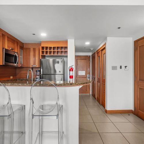Entertain guests effortlessly with this open kitchen design, providing easy access to both the living area and dining spaces.
