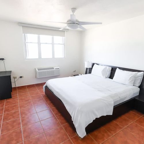 Rise to a bedroom bathed in sunlight and calm.