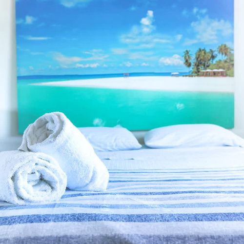 Rise to a bedroom bathed in sunlight and calm.