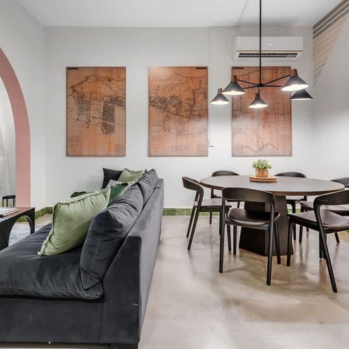 Spacious living area with a stylish dining table, perfect for shared meals and relaxation.