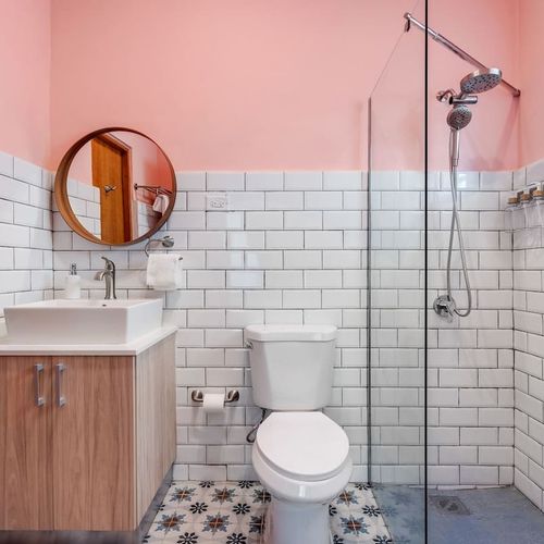 Stylish bathroom with a vanity mirror and a relaxing rain shower.