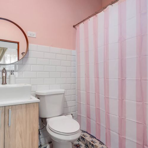 Bright bathroom with a mirror and modern fixtures, perfect for refreshing your routine.