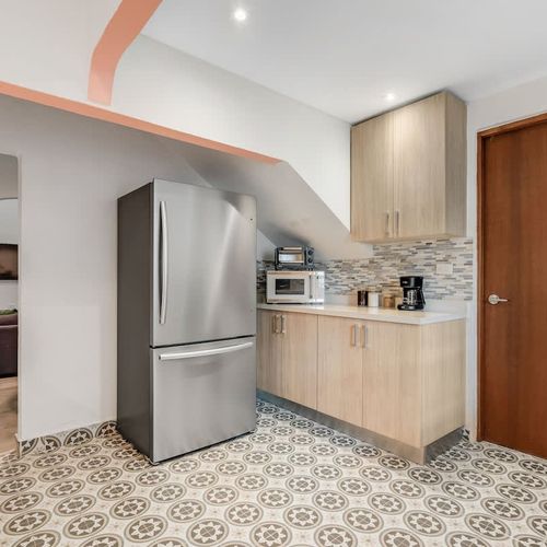 Modern kitchen featuring a full-size refrigerator.