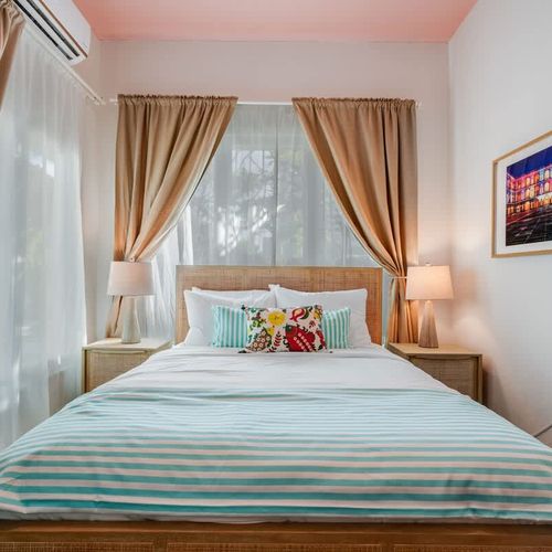 Elegant bedroom featuring a large windows with stunning views.