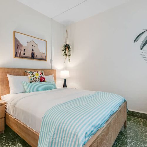 Cozy, modern bedroom, with wall painting and big mirror. Night lamps. Embrace the calming allure of this minimalist bedroom, thoughtfully designed for peaceful rest and ultimate relaxation.