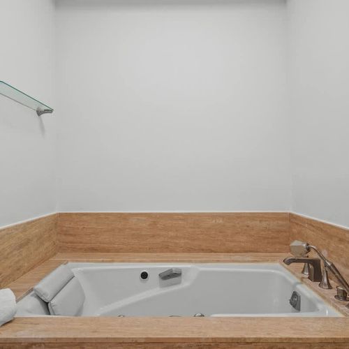 Unwind in luxury with this spacious jacuzzi tub. Relax in style with ample space and modern fixtures, perfect for soaking away the day's stresses.