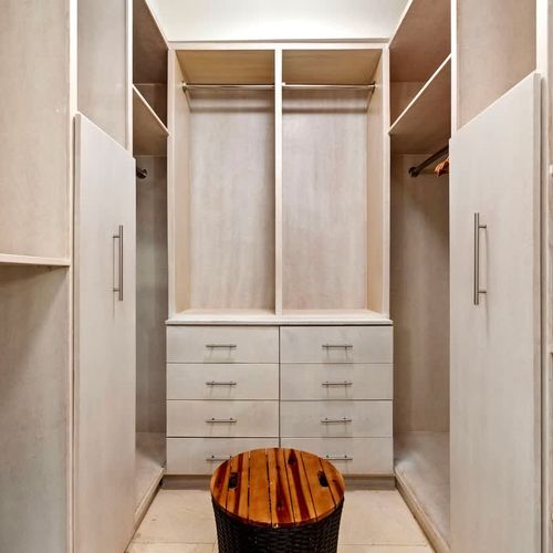 Spacious walk-in closet with ample hanging space and shelving, perfect for organizing your wardrobe.