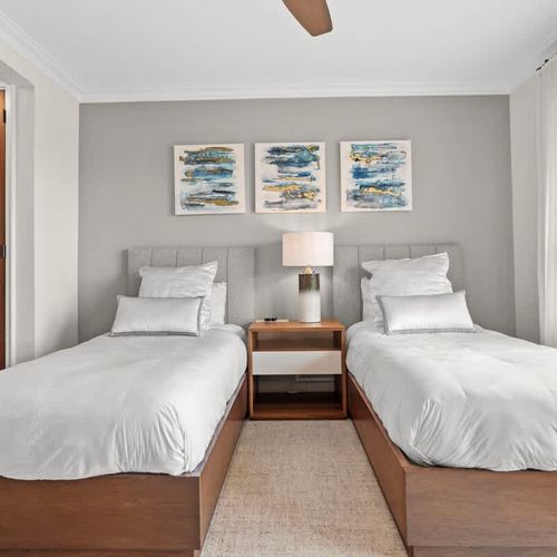 Bright, airy guest room with twin beds.