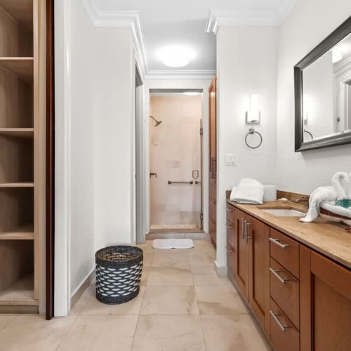 Spacious and elegant ensuite bathroom. Featuring dual vanities with ample counter space, a separate shower, and a generously sized closet.