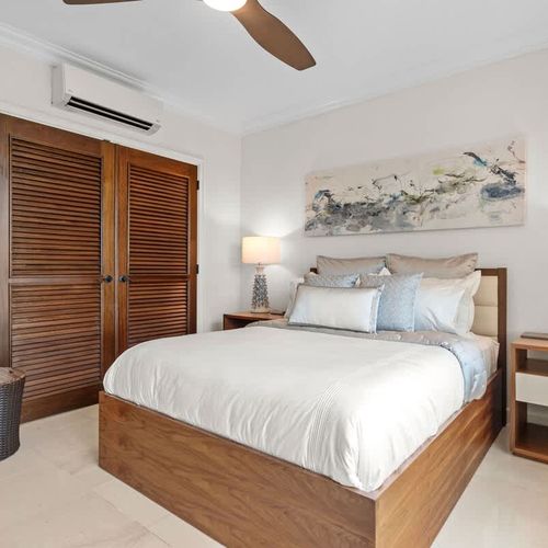 Escape to a serene oasis with this inviting guest bedroom. Featuring a comfortable queen-sized bed adorned with plush linens and a neutral color palette, the room exudes tranquility and relaxation.