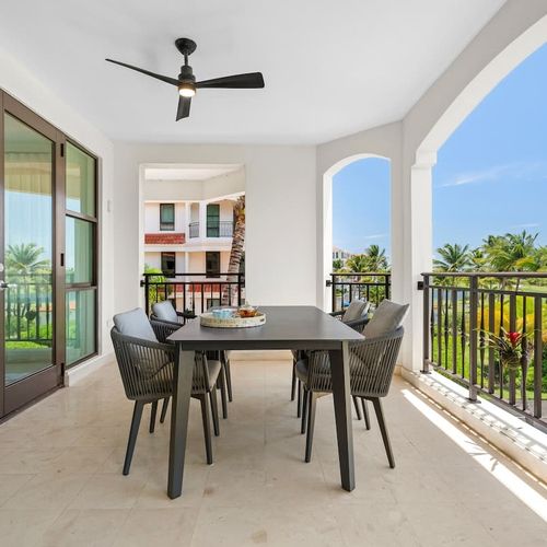 Relax on your private balcony with plush seating and a stylish table, and enjoy stunning views of lush greenery and sparkling water. It’s the perfect spot to unwind and soak in the beauty.