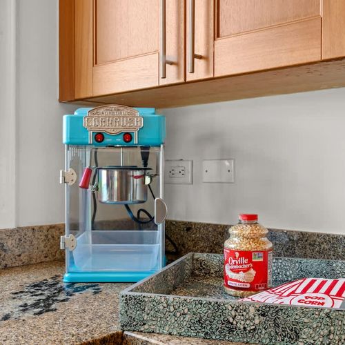 Indulge in classic movie night fun with this vintage-style popcorn maker, a delightful addition to your kitchen entertainment options.