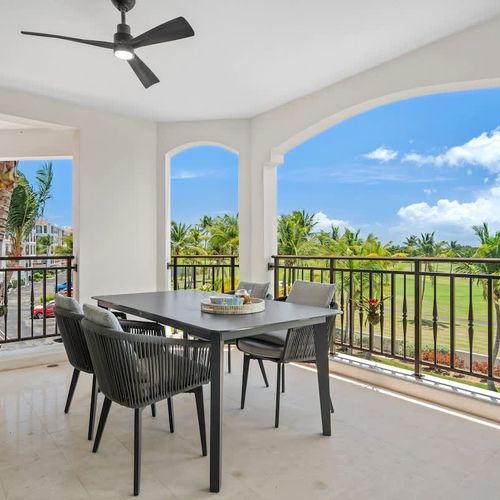 Relax in your private outdoor oasis with plush seating and a stylish side table. Enjoy stunning views of lush greenery and sparkling water—it’s the perfect spot to unwind and savor the scenery.