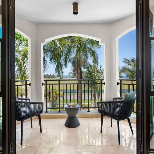 Step onto your private oasis and indulge in breathtaking views. This inviting balcony, complete with plush seating and a stylish side table, offers the perfect escape to unwind and soak in the stunning scenery. From the lush greenery to the sparkling