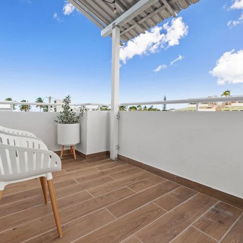 Wake up to the serene views of the cityscape from this cozy balcony!