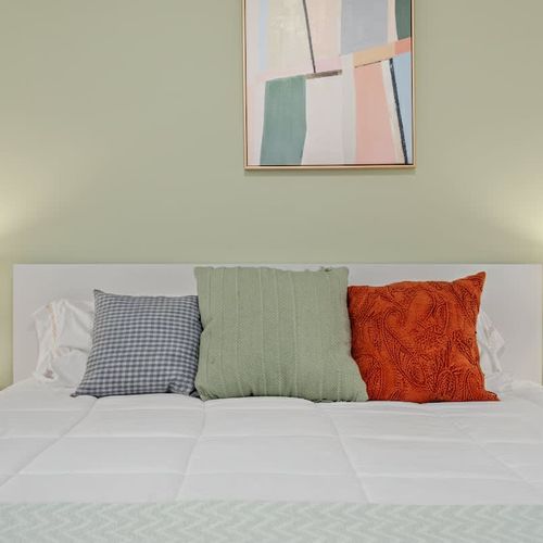 Relaxing bedroom with calming colors and natural light.