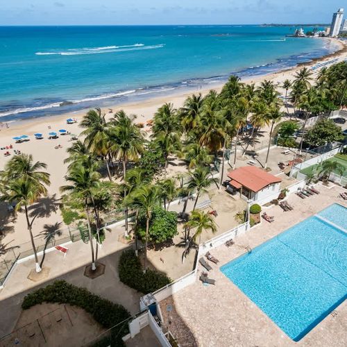 Your resort-style escape! Enjoy direct access to the pristine sandy beach, a sparkling swimming pool, and even a tennis court, all just steps from your door.