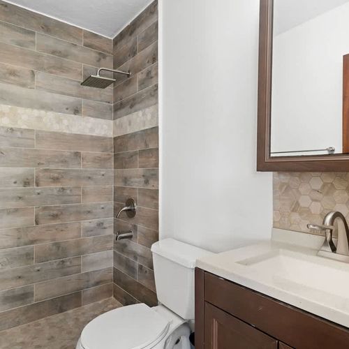 Refresh and rejuvenate! This modern bathroom features a stylish walk-in shower with beautiful tile work and all the essentials for a comfortable start or end to your day."