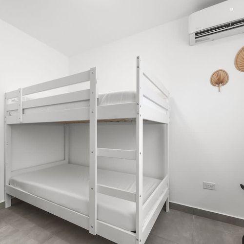 This charming bedroom is perfect for groups, offering a playful and roomy bunk bed for a relaxing night's rest.