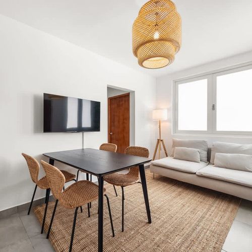 LIVINGROOM, LARGE WINDOW, 4 SEAT DIING TABLE, SMART HD TV,  GREY SOFA, LARGE TREE, CEILING LAMP,  WALL ART, DECOR MAT