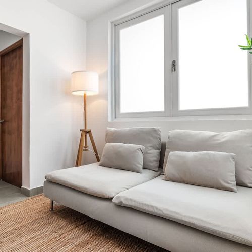 Relax and unwind in this cozy space, featuring a comfortable sofa perfect for lounging or reading.