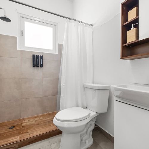 Relax in this stylish bathroom, featuring a refreshing shower and all the amenities for your convenience.