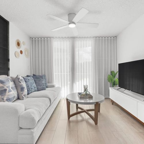 A living room with plenty of space for a small group to gather.