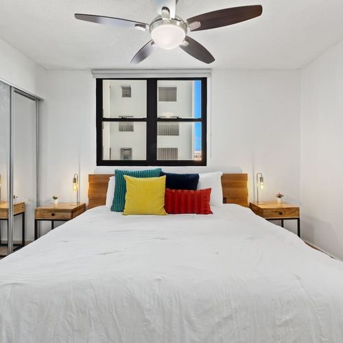 Bright bedroom with natural light and a soothing ceiling fan.
