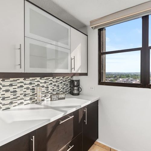 Modern kitchen with beautiful countertops & a scenic view.