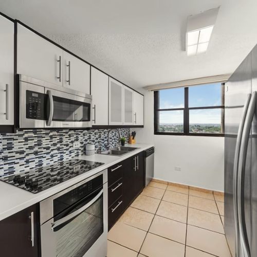 Sleek kitchen with natural light; perfect for morning coffee.