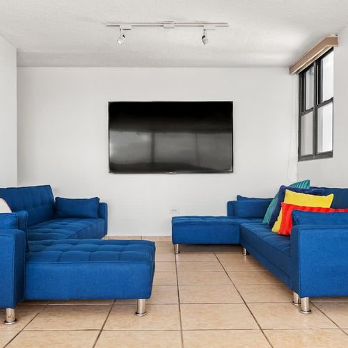 Lounge on the blue sofa, perfect for movie nights.