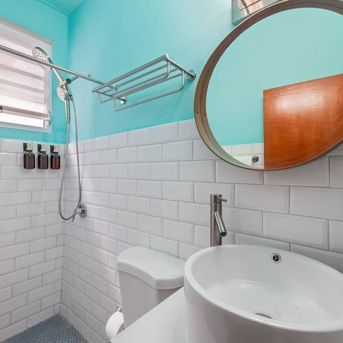 A bright and airy bathroom with refreshing aqua and white tiling.