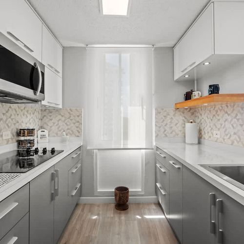 Streamlined for your convenience! This functional kitchen area includes essential appliances and a clean design, making it easy to enjoy meals at your leisure.