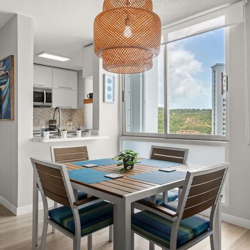 "Dine with a view! This elegant dining area offers comfortable seating for four, with direct access to a private balcony, perfect for enjoying meals with a refreshing breeze and scenic vistas.